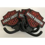 A set of three cast metal coat hooks inscribed "Harley Davidson Motorcycles"