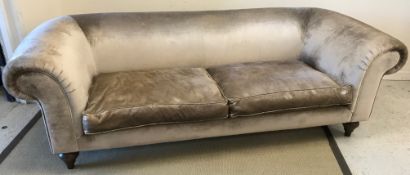 A modern Chesterfield sofa with taupe velvet upholstery, raised on turned and ringed front legs,