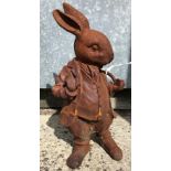 A cast metal figure of "Mr Rabbit" with rust style patination,