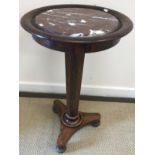 A Victorian rosewood fold-over pedestal card table, raised on octagonal pedestal and quadruped base,