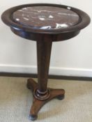 A Victorian rosewood fold-over pedestal card table, raised on octagonal pedestal and quadruped base,