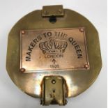 A modern heavy brass compass bearing copper plaque inscribed "Makers to The Queen",