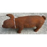 A cast metal figure of a pig, with rust style patination,