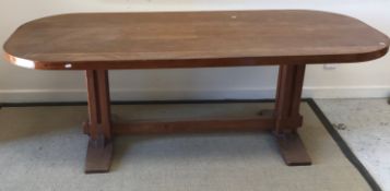 An Arts & Crafts style teak table, the panelled top with rounded corners,