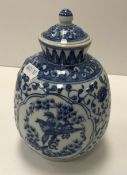 An early to mid 20th Century Chinese blossom and bird decorated vase and cover bearing six