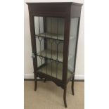 An Edwardian mahogany and inlaid display cabinet with leaded glazed door, raised on swept legs,