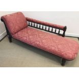 A Victorian upholstered chaise longue with carved wooden frame,