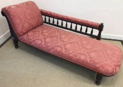 A Victorian upholstered chaise longue with carved wooden frame,