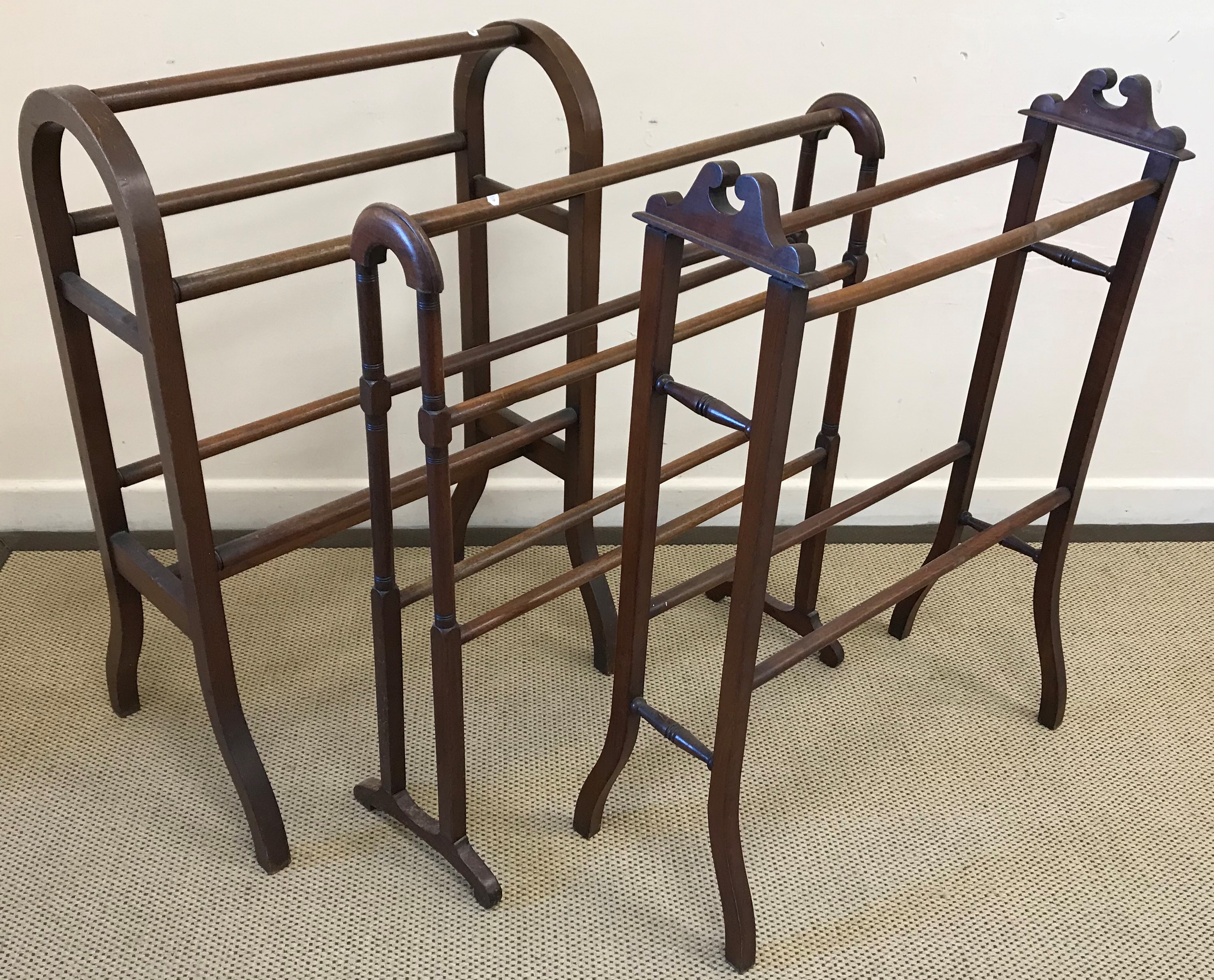 A collection of three late 19th / early 20th Century mahogany towel rails,