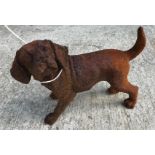 Two cast metal figures of puppies, with rust style patination,