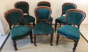 A set of six Victorian dining chairs with green upholstered backs and seats,