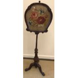 A Victorian mahogany pole screen with embroidered floral spray panel on a cabriole leg base,