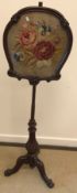 A Victorian mahogany pole screen with embroidered floral spray panel on a cabriole leg base,