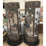 A pair of modern Chinese famille-rose circular stick stands, 61 cm high,