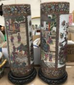 A pair of modern Chinese famille-rose circular stick stands, 61 cm high,