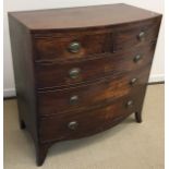 An early 19th Century mahogany bow fronted chest of two short over three long graduated drawers