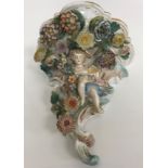A collection of Continental china wares to include a pair of Schierholtz cherub and floral
