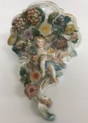 A collection of Continental china wares to include a pair of Schierholtz cherub and floral