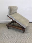 A Victorian walnut framed and upholstered adjustable gout stool,