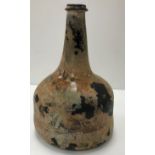 A mid 18th Century English black glass mallet-shaped wine bottle,