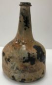 A mid 18th Century English black glass mallet-shaped wine bottle,