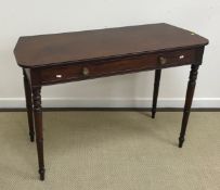 A Regency mahogany side table with reeded top above a single frieze drawer to turned tapering