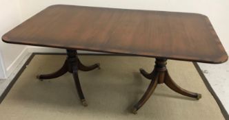 A reproduction mahogany D end twin pedestal dining table, with three leaves (seats 12),