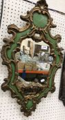 An early 19th Century style wall mirror with C scrolling frame and gilt and green painted