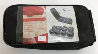 A cased eight piece steel boules set
