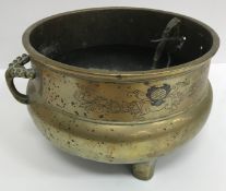 A Chinese bronze twin-handled censer (one handle missing), raised on three feet,