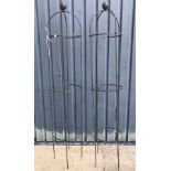 A pair of metal obelisks / plant supports, with verdigris style patination,