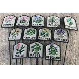 A collection of twelve painted cast metal herb signs inscribed "Basil", "Thyme", "Sage", "Oregano",