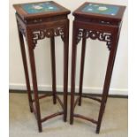 A pair of modern Chinese hardwood plant stands with blue ground floral and butterfly decorated