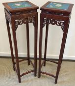 A pair of modern Chinese hardwood plant stands with blue ground floral and butterfly decorated