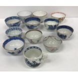 A collection of Oriental and English mainly blue and white tea bowls and cups to include a