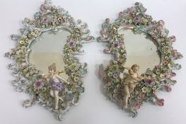 A pair of German porcelain Rococo style mirrors in the Sitzendorf manner,