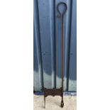 A wrought iron boot scrape with handle,110 cm long including spikes,
