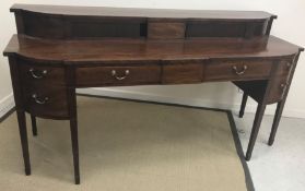 A George III scottish mahogany sideboard, the pair of sliding tambour doors,