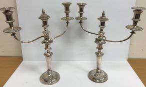 A pair of 20th Century plated two branch three light table candelabra with beaded decoration,