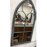 A modern wall mirror of Gothic arched style,