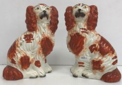 A pair of Staffordshire Spaniel figures, 20 cm high,