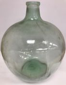 A large glass carboy 54 cm high together with a further large glass vase with writhen type