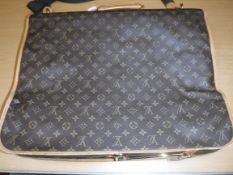 A Louis Vuitton suit bag with shoulder strap,