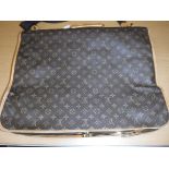 A Louis Vuitton suit bag with shoulder strap,