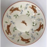 A modern decorative charger painted with running hares, signed to base "L.