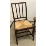 An Edwardian mahogany slat back rush seated Edward VII Coronation chair by Glenister of Wycombe,