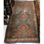 A Caucasian carpet, the central panel set with stylised foliate decoration on a rust ground,