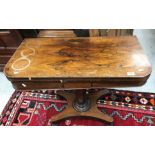 A Victorian rosewood fold over card table on tapering octagonal base to platform quadruped supports