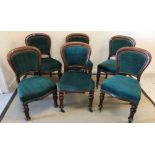 A set of six Victorian dining chairs with green upholstered backs and seats,