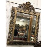 A 19th Century carved oak and gesso decorated Florentine style wall mirror with bevel edged plate,